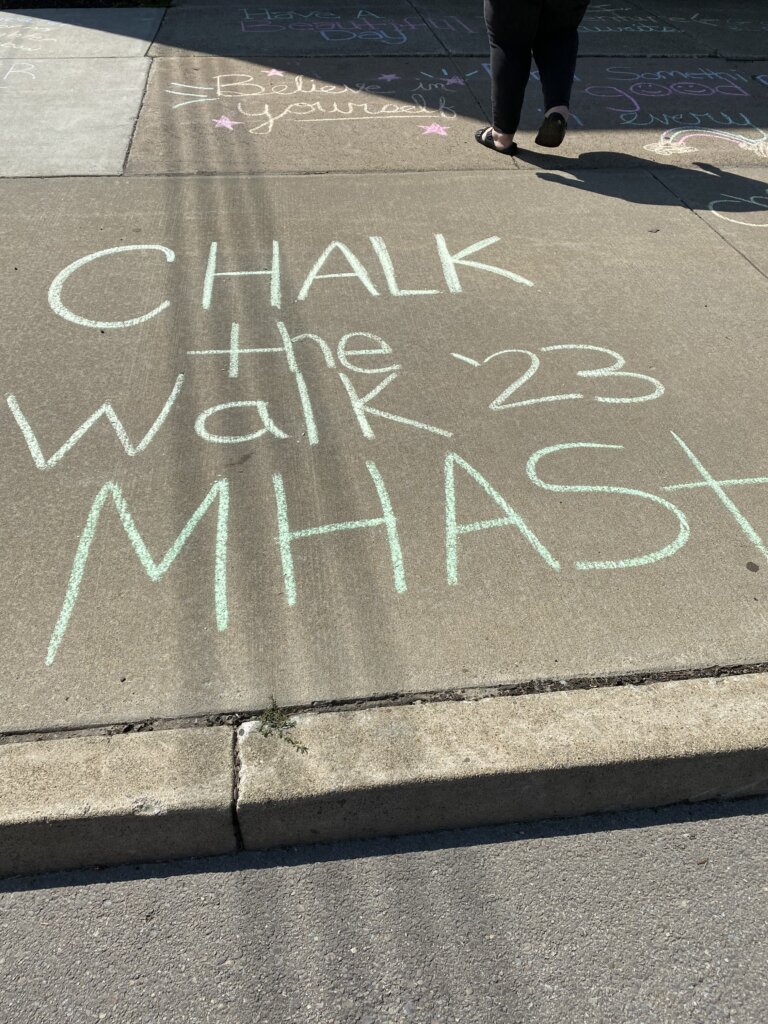 Message written in sidewalk chalk reads: "Chalk The Walk '23 MHAST"