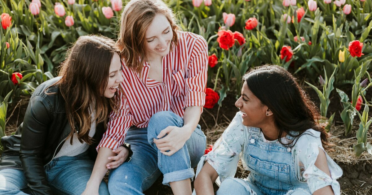 Young women laughing in a tulip garden